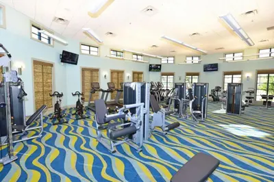 a fitness room with treadmills and cardio machines at DWS Vacation Villas in Orlando