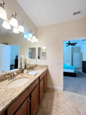 a bathroom with two sinks and a large mirror at DWS Vacation Villas in Orlando