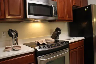 a kitchen with a stove and a microwave at Viz Cay Apartment 202 in Orlando