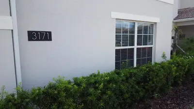 a house with a sign on the side of it at 4 Bedroom Private Lakefront Town Home at Storey Lake near Disney World Parks in Kissimmee
