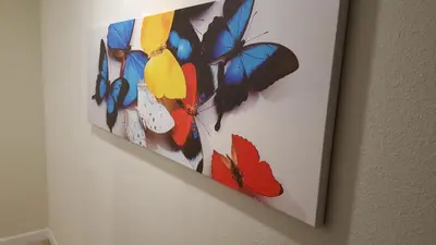 a painting of butterflies hanging on a wall at 4 Bedroom Private Lakefront Town Home at Storey Lake near Disney World Parks in Kissimmee