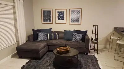 a living room with a couch and a table at 4 Bedroom Private Lakefront Town Home at Storey Lake near Disney World Parks in Kissimmee