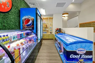 a store aisle with a cool zone and a shelf of drinks at Regal Oaks Resort Vacation Townhomes by IDILIQ in Orlando