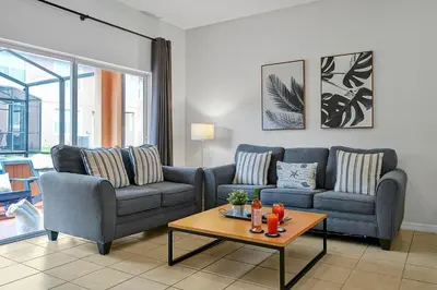 a living room with two couches and a coffee table at Regal Oaks Resort Vacation Townhomes by IDILIQ in Orlando