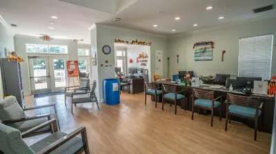 a room with chairs and a bar with a counter at Barefoot Suite in Orlando