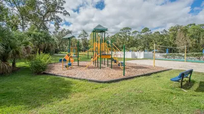 a playground with a slide in a park at Barefoot Suite in Orlando