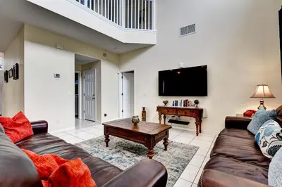 a living room with a couch and a table at Margaritavilla at Emerald Island in Kissimmee