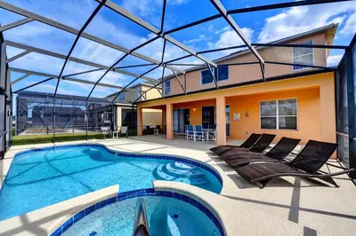 a house with a swimming pool with a glass ceiling at Margaritavilla at Emerald Island in Kissimmee