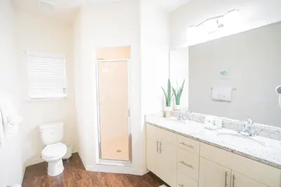 a white bathroom with a toilet and a sink at Dream Vacation Home! in Kissimmee