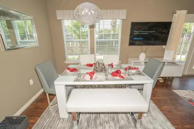 a dining room with a white table and chairs at Dream Vacation Home! in Kissimmee