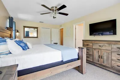 a bedroom with a bed and a flat screen tv at Scarlet in Orlando