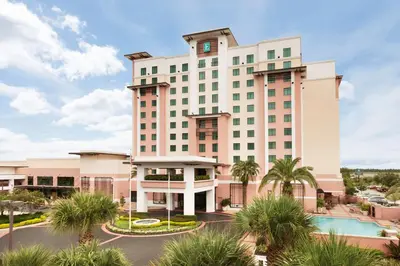 a rendering of a hotel with a pool at Embassy Suites by Hilton Orlando Lake Buena Vista South in Kissimmee