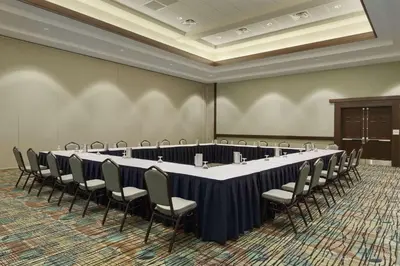 a large conference room with a long table and chairs at Embassy Suites by Hilton Orlando Lake Buena Vista South in Kissimmee