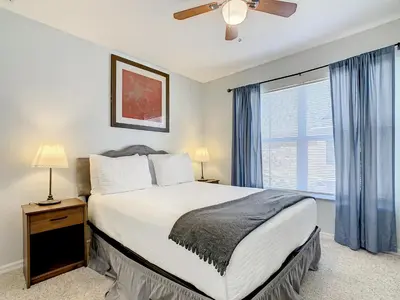 a bedroom with a bed and a large window at 4 Bedroom Townhouse in a Gated Resort! in Kissimmee