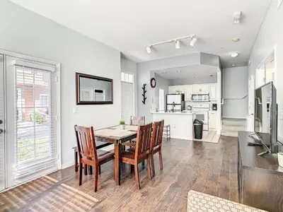 a kitchen and dining room with a table and chairs at 4 Bedroom Townhouse in a Gated Resort! in Kissimmee