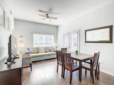 a living room with a table and a couch at 4 Bedroom Townhouse in a Gated Resort! in Kissimmee