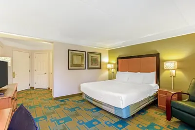 a hotel room with a bed and a couch at La Quinta by Wyndham Orlando I Drive/Conv Center in Orlando