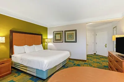 a hotel room with a bed and a television at La Quinta by Wyndham Orlando I Drive/Conv Center in Orlando