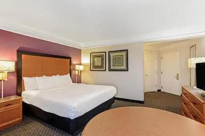 a hotel room with a bed and a flat screen tv at La Quinta by Wyndham Orlando I Drive/Conv Center in Orlando
