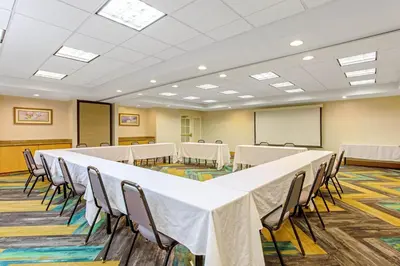a conference room with a long table and chairs at La Quinta by Wyndham Orlando I Drive/Conv Center in Orlando