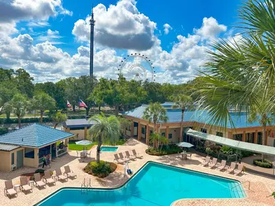 an aerial view of a resort with a pool and a ferris wheel at Hotel Monreale Express & Studios IDrive District in Orlando