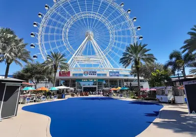 a large ferris wheel in front of a mall at Hotel Monreale Express & Studios IDrive District in Orlando
