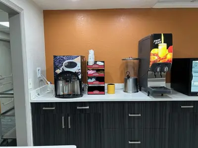 a kitchen counter with a appliance on top of it at Baymont by Wyndham Orlando South in Orlando