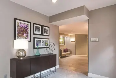 a room with a hallway with a living room at La Quinta by Wyndham Orlando UCF in Orlando