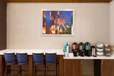 a bar with four blue chairs and a ferris wheel at Homewood Suites by Hilton Orlando-International Drive Convention Center in Orlando