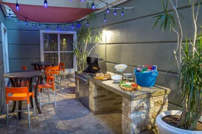 a patio with a table and chairs and a grill at Homewood Suites by Hilton Orlando-International Drive Convention Center in Orlando