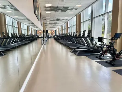 a gym with rows of treadmills and exercise bikes at Hilton Orlando in Orlando