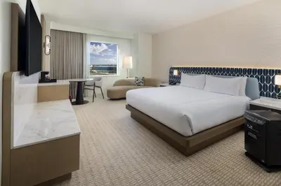 a hotel room with a large bed and a couch at Hilton Orlando in Orlando