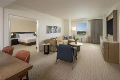 a hotel room with a bed and a living room at Hilton Orlando in Orlando