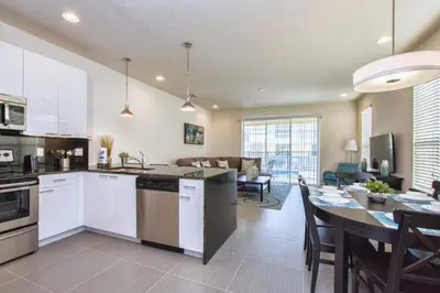 a kitchen and living room with a table and a dining room at Silver Creek - 3 Bed Townhouse Wsplashpool-5003Sc in Orlando