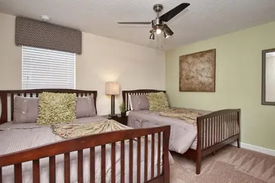 a bedroom with two beds and a ceiling fan at Paradise Palms- 6 Bedroom Pool Home-3150Pp in Kissimmee