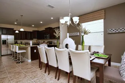 a kitchen and dining room with a table and chairs at Paradise Palms- 6 Bedroom Pool Home-3150Pp in Kissimmee