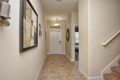 a hallway of a home with stairs and a door at House Wpool And Jacuzzi In Paradise Palms-3151Pp in Kissimmee