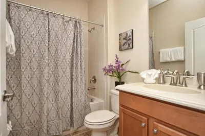 a bathroom with a toilet and a sink and a shower at House Wpool And Jacuzzi In Paradise Palms-3151Pp in Kissimmee