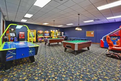 a room with several arcade games and pool tables at House Wpool And Jacuzzi In Paradise Palms-3151Pp in Kissimmee