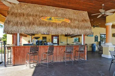 a bar with a surfboard on top of it at Paradise Palms-4 Bed Townhome W-Splashpool-3035Pp in Kissimmee