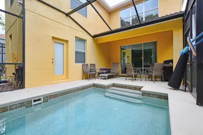 a swimming pool in front of a house at Conservation View, Resort, Pool Home-3116Pp in Kissimmee