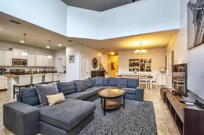 a large living room with a blue couch and a kitchen at Conservation View, Resort, Pool Home-3116Pp in Kissimmee