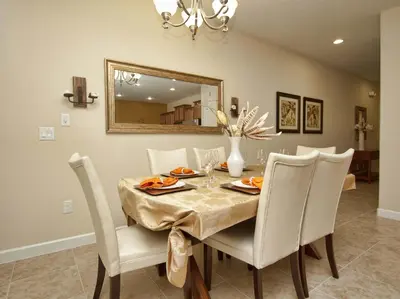 a dining room table with white chairs and a mirror at Dog Friendly Townhome W Splashpool-3202Pp in Kissimmee