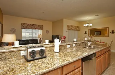 a kitchen with a granite counter top and a sink at Dog Friendly Townhome W Splashpool-3202Pp in Kissimmee