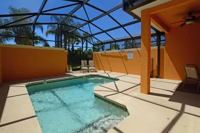 a swimming pool on a patio with a building at Close To Clubhouse, Bbq, Wifi-3001Ppr in Kissimmee