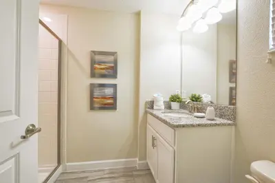 a bathroom with a sink and a mirror at Lakefront Retreat Wpvt Splashpool-1617St in Kissimmee