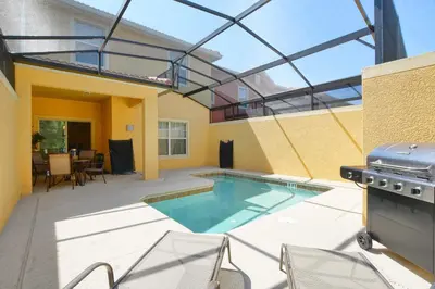 a patio with a swimming pool and a grill at Paradise Palms-4 Bed Townhouse Wsplashpool3622Ppr in Kissimmee