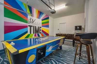 a ping pong table in a room with a colorful wall at Across From Clubhouse, Private PoolSpa-1651Str in Kissimmee