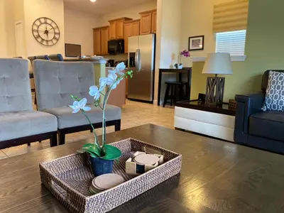 a living room with a couch and a table at Beautiful Waterfront Townhome Wsplashpool-3024 in Kissimmee