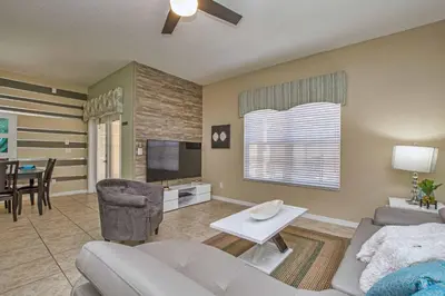a living room with a couch and a tv at Pvt Splashpool, Bbq Grill, Close To Parks-3057Pp in Kissimmee
